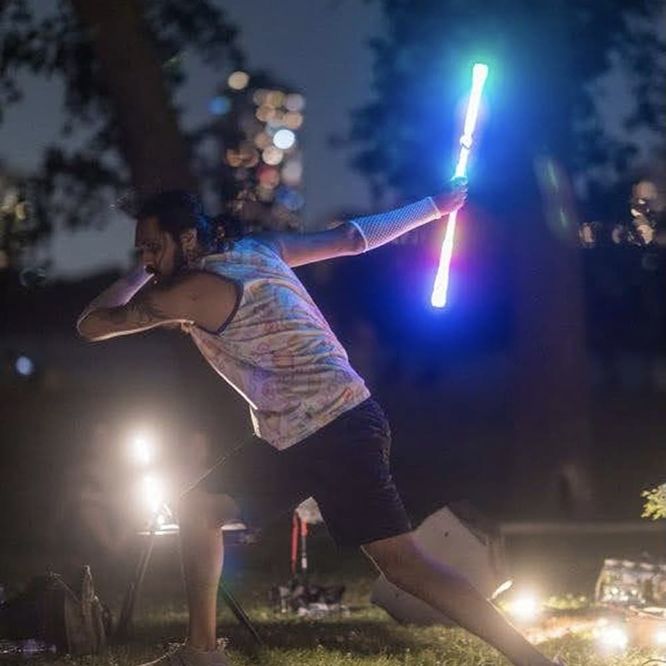 Mustafa flowing at night with a Flow Toys wand